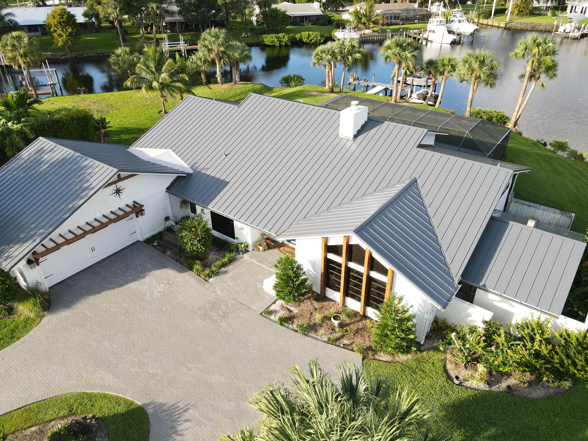 Waterfront Home with Charcoal Grey 1" Nail Strip Metal Roof Charcoal grey 1" Nail Strip metal roofing on a modern residential waterfront home with standing seam profile